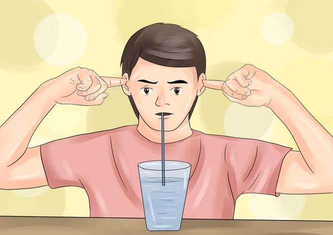 Drink a glass of water through a straw and plug your ears